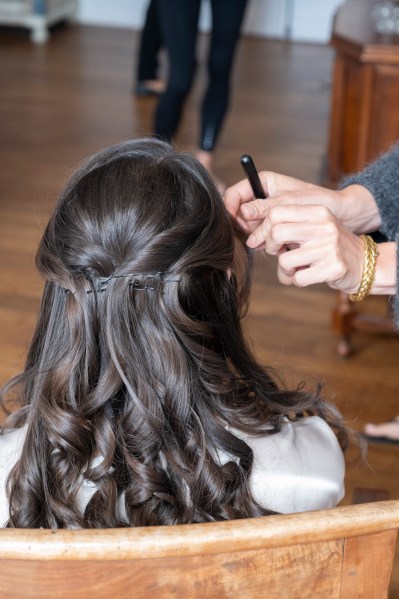 Back of hair detail as MUA does hair and makeup for bride